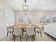 Elegant dining area with a wooden table, stylish lighting, and plenty of natural light from surrounding windows at 1761 Dosk Ave, Lawrenceville, GA 30044