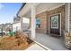 Inviting front porch with brick accents, a decorated door, and manicured landscaping at 1761 Dosk Ave, Lawrenceville, GA 30044