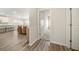 Hallway view into the modern living room and kitchen, light hardwood flooring at 1761 Dosk Ave, Lawrenceville, GA 30044