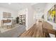 Hallway with hardwood floors leading to an office featuring a large desk and a view of the living room at 1761 Dosk Ave, Lawrenceville, GA 30044