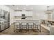 Modern kitchen with stainless steel appliances, a large island with seating, and an adjacent dining area at 1761 Dosk Ave, Lawrenceville, GA 30044