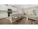 Modern kitchen with stainless steel appliances, a large island, and seamless connection to the dining and living spaces at 1761 Dosk Ave, Lawrenceville, GA 30044