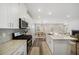 Modern kitchen with stainless steel appliances, granite countertops, and an open view to the dining and living areas at 1761 Dosk Ave, Lawrenceville, GA 30044