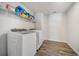 Functional laundry room featuring modern washer and dryer, with overhead shelving for optimal storage at 1761 Dosk Ave, Lawrenceville, GA 30044
