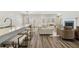 Bright, open-concept living room with a fireplace, modern decor, and seamless flow to the kitchen and dining area at 1761 Dosk Ave, Lawrenceville, GA 30044