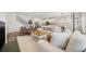 Open-concept living room with white sofa, modern decor and hardwood flooring at 1761 Dosk Ave, Lawrenceville, GA 30044