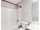 Full white bathroom features a tub and shower combination at 603 Stonecrest Dr, Loganville, GA 30052