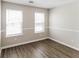 This bedroom has wood floors, a big window and is freshly painted at 603 Stonecrest Dr, Loganville, GA 30052