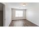 This bedroom has wood floors, a big window and is freshly painted at 603 Stonecrest Dr, Loganville, GA 30052