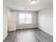 This bedroom has wood floors, a big window and is freshly painted at 603 Stonecrest Dr, Loganville, GA 30052