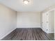 This bedroom has wood floors, a big window and is freshly painted at 603 Stonecrest Dr, Loganville, GA 30052
