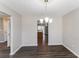 Neutral dining room featuring modern floors and a view into the kitchen and back yard at 603 Stonecrest Dr, Loganville, GA 30052