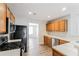 Well-lit kitchen with stainless steel appliances, wood cabinets, and modern flooring at 603 Stonecrest Dr, Loganville, GA 30052