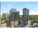 City view from a balcony with views of tall buildings and green trees at 860 Peachtree Ne St # 2001, Atlanta, GA 30308