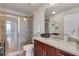 Modern bathroom features glass shower door, granite vanity top, and decorative shelving at 860 Peachtree Ne St # 2001, Atlanta, GA 30308