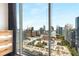 Spacious bedroom with hardwood floors, a large window, and scenic city views at 860 Peachtree Ne St # 2001, Atlanta, GA 30308
