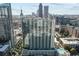 Aerial view of a modern high-rise building with a pool and lush landscaping in a bustling city at 860 Peachtree Ne St # 2001, Atlanta, GA 30308