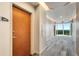 Hallway entrance with unit number featuring view of the city skyline through large windows at 860 Peachtree Ne St # 2001, Atlanta, GA 30308