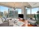 Inviting living room with floor-to-ceiling windows offering city views, hardwood floors, and a modern chandelier at 860 Peachtree Ne St # 2001, Atlanta, GA 30308