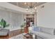 Bright living room with a concrete accent wall, hardwood floors, and a view into the adjacent kitchen at 860 Peachtree Ne St # 2001, Atlanta, GA 30308
