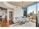 Cozy living room featuring hardwood floors, city views, and an adjacent bathroom with a glass-enclosed shower at 860 Peachtree Ne St # 2001, Atlanta, GA 30308