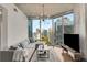 Modern living room boasting expansive windows with views of the city skyline, hardwood floors, and concrete ceilings at 860 Peachtree Ne St # 2001, Atlanta, GA 30308