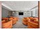 Comfortable lounge area furnished with orange, curved seating for social gatherings and relaxation at 860 Peachtree Ne St # 2001, Atlanta, GA 30308