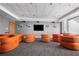 Comfortable lounge area furnished with orange, curved seating for social gatherings and relaxation at 860 Peachtree Ne St # 2001, Atlanta, GA 30308