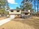 Charming split-level home featuring a stone facade, front porch, and well-manicured lawn at 10839 Mallard Dr, Jonesboro, GA 30238