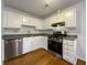Efficient kitchen with white cabinets, modern stainless steel appliances, and durable countertops at 10839 Mallard Dr, Jonesboro, GA 30238