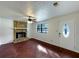 The living room has a stone fireplace, hardwood floors, and abundant natural light from windows at 10839 Mallard Dr, Jonesboro, GA 30238