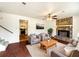 Staged living room features a stone fireplace, hardwood floors, and neutral-toned furniture at 10839 Mallard Dr, Jonesboro, GA 30238