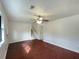 Inviting living room features hardwood floors, a ceiling fan, and easy access to the staircase at 10839 Mallard Dr, Jonesboro, GA 30238