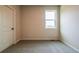 Bright bedroom with carpet and a large window at 142 Henley St, Canton, GA 30114