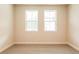 A room with carpet and two windows allowing natural light at 142 Henley St, Canton, GA 30114