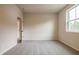 Bedroom with carpet, window and door to the hallway at 142 Henley St, Canton, GA 30114