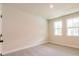 Bright, carpeted bedroom with two windows providing natural light at 142 Henley St, Canton, GA 30114
