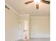 Bright bedroom with a ceiling fan, neutral color scheme, and access to a hallway at 142 Henley St, Canton, GA 30114