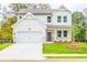 Charming two-story home with a well-manicured lawn and attached two-car garage at 142 Henley St, Canton, GA 30114