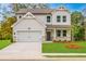 Charming two-story home with a well-manicured lawn and attached two-car garage at 142 Henley St, Canton, GA 30114