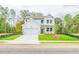 Beautifully designed two-story home with white siding, lush lawn, and a two-car garage at 142 Henley St, Canton, GA 30114