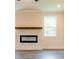 Close-up of a modern fireplace with a decorative mantel, set against light-colored walls at 142 Henley St, Canton, GA 30114