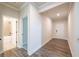 Hallway with hardwood floors leading to an open door and view of the bathroom at 142 Henley St, Canton, GA 30114