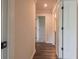 Hallway with hardwood floors and white trim featuring doors to other rooms at 142 Henley St, Canton, GA 30114
