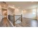 Open hallway with wood floors, natural light, and a staircase leading to the basement at 142 Henley St, Canton, GA 30114