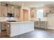 Modern kitchen with gray cabinets, stainless steel appliances, and a white countertop island at 142 Henley St, Canton, GA 30114