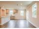 Open layout kitchen with a white kitchen island, stainless steel appliances, and hardwood flooring at 142 Henley St, Canton, GA 30114