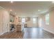 An open floor plan showcasing a kitchen with gray cabinetry, a center island, and wood flooring at 142 Henley St, Canton, GA 30114