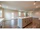 Bright, open floor plan features a kitchen island with white countertop and space for seating at 142 Henley St, Canton, GA 30114