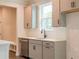 Modern kitchen with gray cabinets, stainless steel dishwasher, and sleek countertops at 142 Henley St, Canton, GA 30114